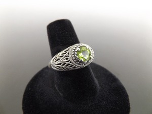 lot 51 image: .925 Sterling Silver Faceted Peridot Scrolled Ring Size 8