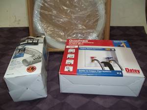 lot 110 image: Washer Outlet Box, Dryer Hook-up Kit, and Fridge Tubing
