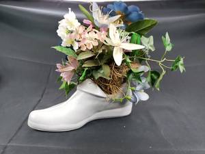 lot 12 image: Decorative Ceramic Shoe Vase with Fake Flowers