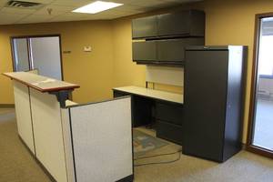 lot 81 image: Reception Cubicle Area with Front Desk, Table, Overhead File Cabinets, Metal Office Storage Cabinet
