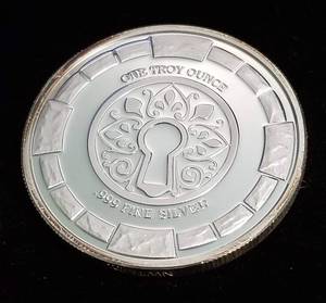 lot 47 image: 1 TROY OZ. .999 FINE SILVER STANSBURY RESEARCH KEY ROUND