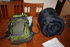 lot 147 image: Survival Backpack, Sleeping Bag, NOAA Weather Radio, Medical Kit, Coleman Plastic Reusable Bags, Flashlight, Rope, Weather Gear, And More