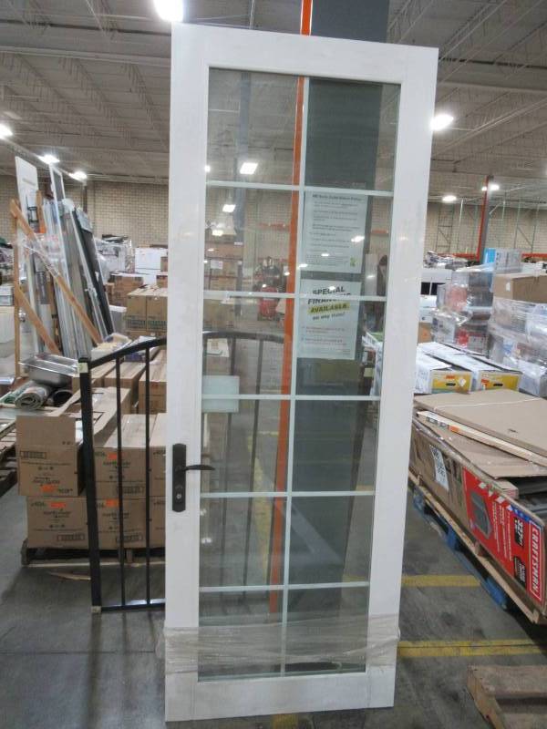 lot 341 image: Millgard 12 lite, Full Window, Internal Grill, Low-E Argon Filled Vinyl Patio Door 33 12 X 92 12 Tall in White With Black Handles and Hinges.