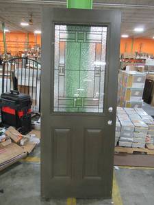 lot 263 image: Dark Brown Fiberglass Exterior Door Slab, 2 Panel 12 Lite, with intricate motif. Double Bore - Looks like it was briefly installed