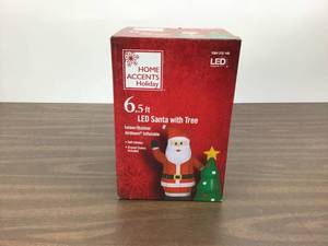 lot 69 image: Home Accents Holiday 6.50 ft. Pre-Lit Life Size Airblown Inflatable Santa with Christmas Tree