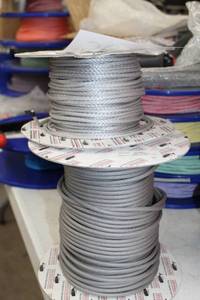 lot 56 image: Lot of (2) Buccaneer Rope Company 3mm STS-HSR 75 Silver Rope 330 Foot Reel, 5mm STS WR2-CTD Gray 200 Foot Reel