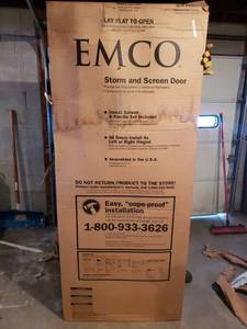 lot 10 image: Emco 200 Series  Storm and Screen Door, New with Damaged Screen