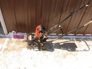 Troy Bilt 2 cycle mini roto tiller. Lightly used. Fires on ether. As shown.