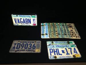 lot 54 image: Lot of 12 license plates and 1 front step mount