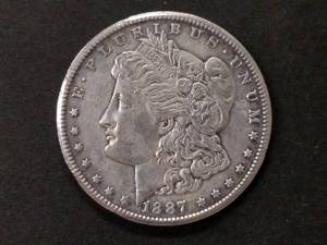 lot 22 image: 1887 S Morgan Silver Dollar...