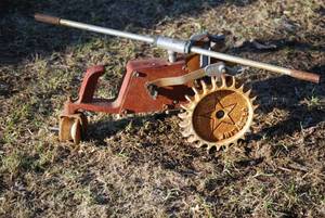 lot 22 image: Antique cast iron Walking Tractor sprinkler