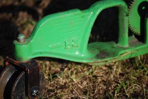 lot 24 image: Antique cast iron Walking Tractor sprinkler