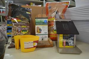 lot 122 image: (2) Squirrel Feeders w (2) Bags of Food and Scoop