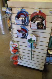 lot 206 image: Contents of Shelf Side B - Pet Tie Outs, Spiral Stakes, Leashes and More