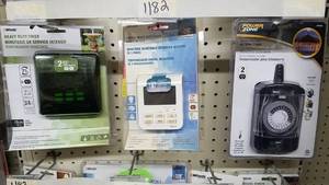 lot 1182 image: (3) Woods Lighting Timers and Smart Bulb Changer