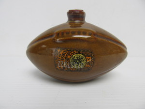 lot 86 image: Old Vintage Miniature Stoneware Football Whiskey Nipper Bottle w MN State Tax Stamp
