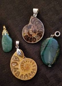 lot 6 image: Fossilized Nautilus Shell and Quartz Pendants, Lot of 4