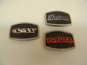lot 40 image: 3 VINTAGE AUTO BELT BUCKLES - VW, TOYOTA, DATSUN - SEE PICTURES