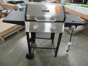 lot 273 image: Dyna-Glo 2-Burner Open Cart Propane Gas Grill in Stainless Steel and Black with Side Burner DGF350CSP-D. - Missing Parts, Grates, Warming Rack, heat tent, Leveling legs Thermostat.  For parts or restore