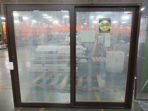 lot 2 image: Pella Custom Sliding Patio Door in Brown With Screen. Measures Approximately 95 14 X 79 12 T X 4 916.