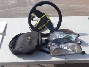 lot 44 image: 2-RZR Head Lights, RZR Steering Wheel, Quad Bag