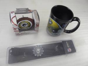 lot 66 image: Brand New Green Bay Packer Fans Football Ornament, Ceramic Mug, and Sport Watch Lot