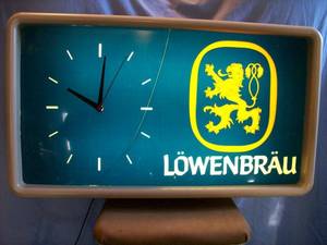 Lowenbrau ClockSign. Approx. 31 x 18. Face & Plastic can have cracks that have been glued. Clock & Light work. As shown.