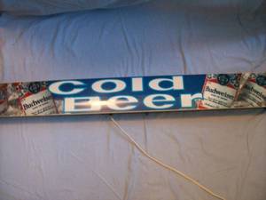 Budweiser Sign. Approx. 48 x 6. Steel can plastic face. Works but one end cap is broken. As shown.