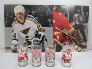 lot 112 image: 2 Vintage Sporting Goods Store Advertising Cooper Hockey Signs & Red Wings Glasses