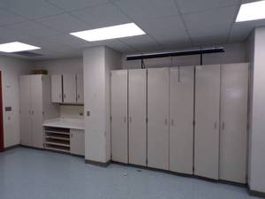 lot 31 image: Wall of Cabinets and countertop with shelves
