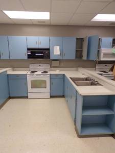 lot 42 image: 8 x 8 Kitchenette with sink, Stove, and Microwave with counter and cabinets