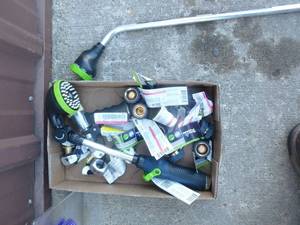 Flat of misc garden hose connectors & wand. As shown.