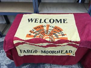 lot 63 image: Welcome  A Century Together Fargo-Moorhead Flag