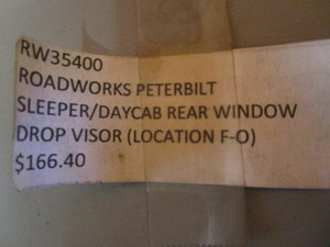 lot 86 image: (New) Stainless Steel Peterbilt Rear Window Drop Visor