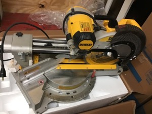 DEWALT 15 Amp 12 in. Double Bevel Sliding Compound Miter Saw in working conditions