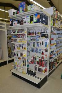 lot 9 image: Store Shelving - 4 Foot Single Sided Section Including Sliding Panels and Shelves with Peg Board Backing & Storage Drawer