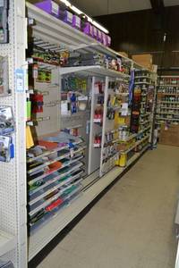 lot 25 image: Store Shelving - 4 Foot Double Sided Section Including Sliding Panels and Shelves with Peg Board Backing & Storage Drawer