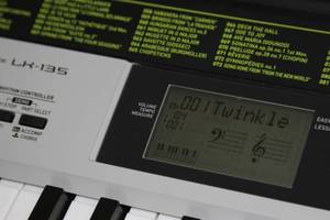 lot 21 image: Casio LK-135 61-Key PianoElectricElectronic Keyboard with Lighted Keys & Folding Stand
