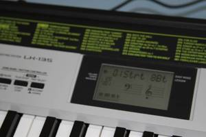 lot 22 image: Casio LK-135 61-Key PianoElectricElectronic Keyboard with Lighted Keys & Folding Stand