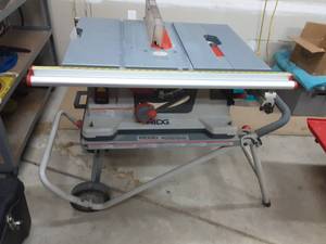 lot 11 image: Ridgid Model AC9930 0 Work-N-Haul-It (2 Wheel Work Stand & Saw)