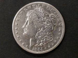 lot 13 image: 1884 S Morgan Silver Dollar...