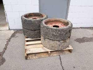 lot 54 image: (4) Solid BobcatSkid loader Wheels