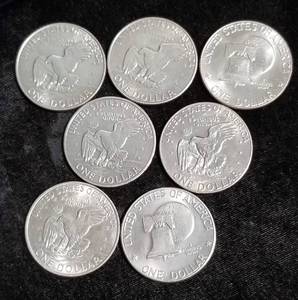 lot 54 image: GROUP OF 7 CLAD EISENHOWER DOLLARS
