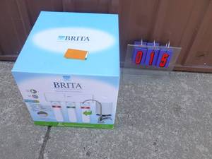 lot 15 image: Brita under sink water filtration system. New in the box. As shown.