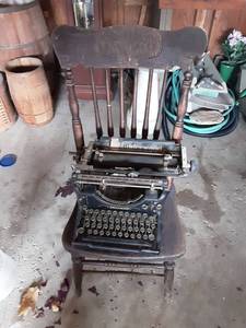 lot 154 image: Vintage Press Back Wood Chair & Underwood Manual Typewriter