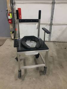lot 61 image: WOW MSRP $1800 NEW Stainless steel&nbspFrame&nbspBedside Shower Chair Commode With Dropping Arms 1000lb Capacity Wheelchair - Can also be wheeled in over your current toilet for ease of patient transfer and privacy 