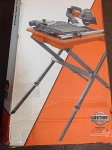 lot 107 image: RIDGID 9 Amp Corded 7 in. Wet Tile Saw with Stand in good conditions