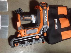 lot 106 image: RIDGID 18-Volt Cordless Brushless HYPERDRIVE 16-Gauge 2-12 in. Straight Finish Nailer(Tool Only), Belt Clip, Bag, Sample Nails in good conditions