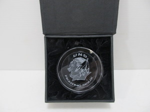 lot 152 image: Solid Etched Crystal UND Fighting Sioux Hockey Puck Paperweight