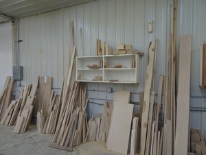 lot 77 image: Misc. wood along wall and white open cabinet